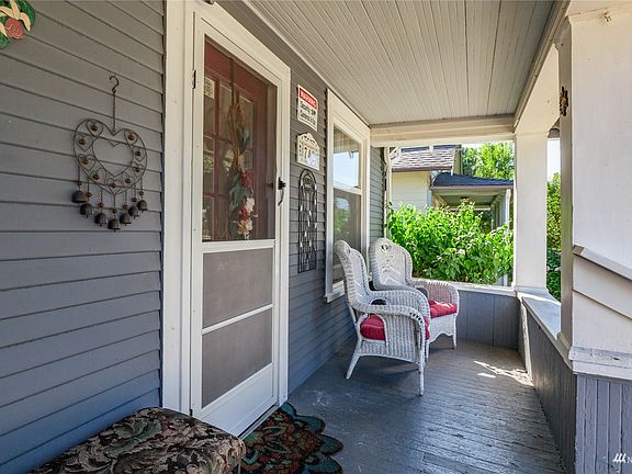 A partial view of the covered porch, with plenty of space to relax in all weather.>