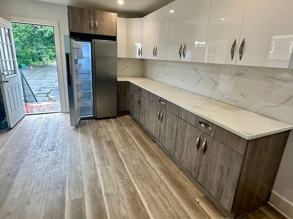 Newly refurbished kitchen / stainless steel SAMSUNG large capacity refrigerator freezer side by side.