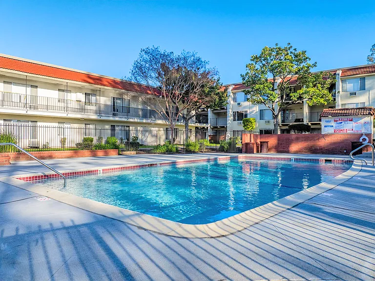 Sparkling pool with spacious deck and sun-filled seating.