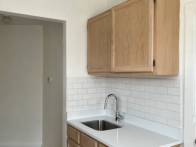 Kitchen sink work area.
Wood cabinets.