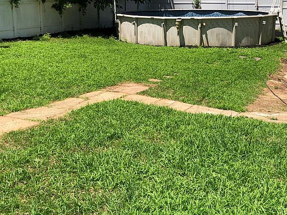 above ground pool with large fenced yard
