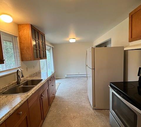 Newer kitchen cabinets and countertop in the galley kitchen. One bedroom off the kitchen. Master and remaining bedroom on other side of the home.