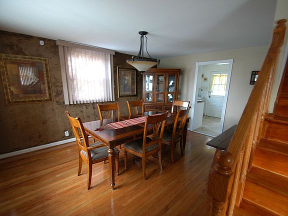 Dining Room with bay window and  entrance door.