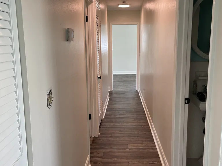 Main hallway with linen closet storage.