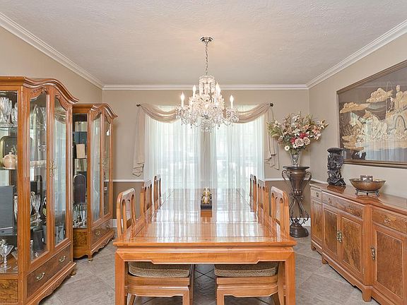 LARGE FORMAL DINING WITH ELEGANT CHANDELIER.
