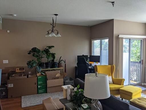 Living room to the left of fireplace, showing entry to the balcony.