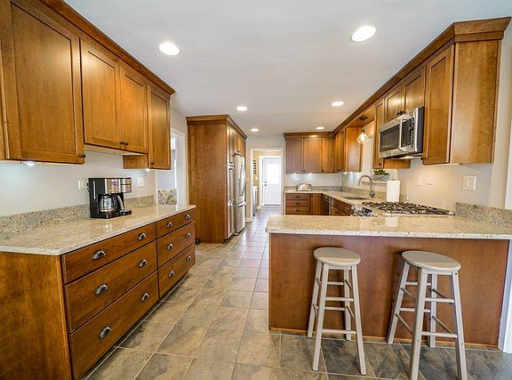 Remodeled with new cabinetry, granite countertops, stainless steel appliances (all included), breakf