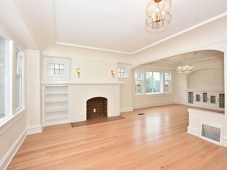 Living space with decorative old fireplace for charm.