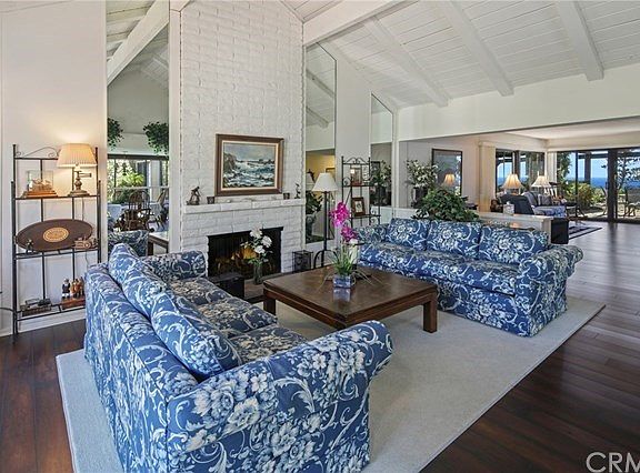 Living Room with open Beamed Ceilings and Fireplace