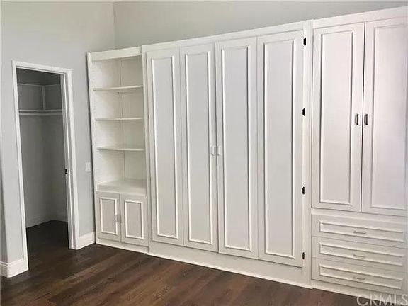 2nd bedroom has built in Murphy bed with storage, walk in closet, large window with plantation shutters. This room works well for visiting guests as well as being used for office, game/ TV room etc.