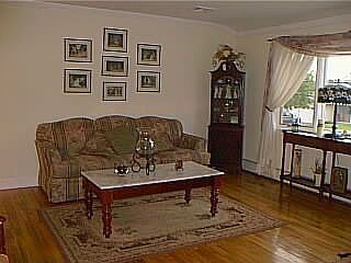Living room with hardwood floors & crown moldings