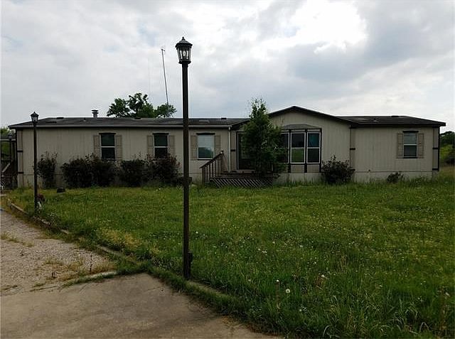 Front of the home. Detached garage is the the left.