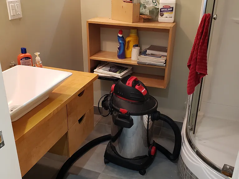 Finished full bathroom with built-in corner shower. Bathroom is currently not being used pending replacement of toilet / pump.