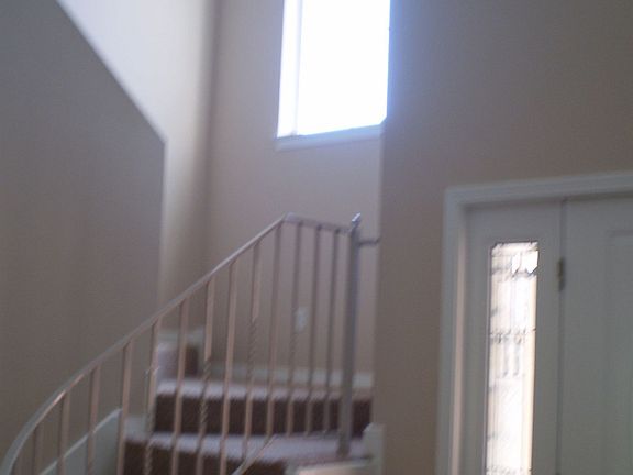 Front door with view of the steps leading to the upstairs