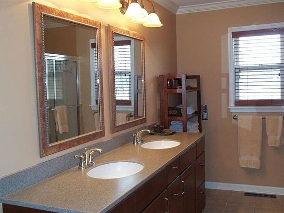 "This spacious bath has a Corian countertop and pewter faucets."