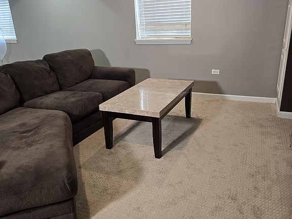 Large Comfy Brown Couch with solid slate table.