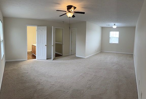 Luxurious primary suite with sitting area and new carpet and paint