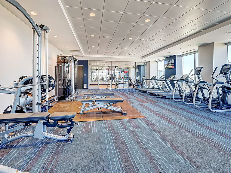 Modern, top of the line fitness center with cardio and stationary workout equipment