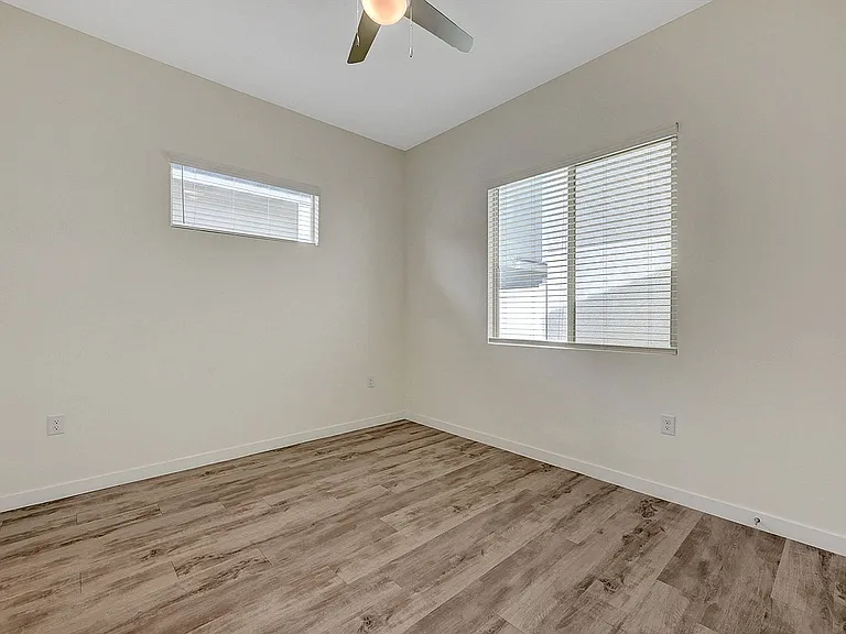 Experience comfort in this serene bedroom filled with natural light.