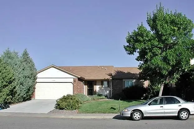 Front exterior. The patio and walkway have recently been replaced with new concrete and several overgrown trees and shrubs have been removed.