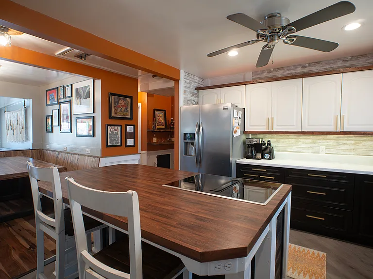 Custom kitchen with oversized island. Kitchen includes ample lighting, automatic dustpans (for easy sweeping - connected to central vac) dishwasher, garbage disposal, wall oven, wall microwave, and electric downdraft cooktop.