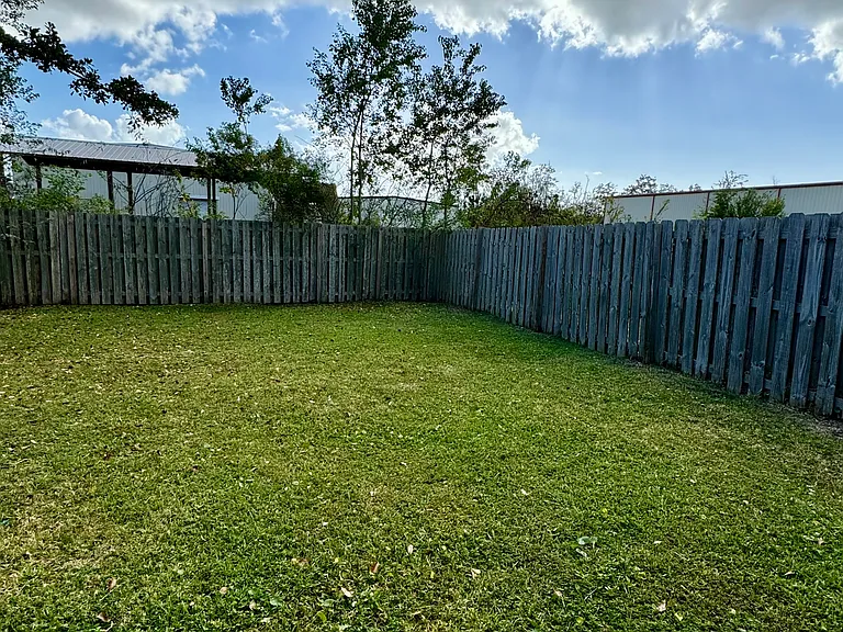 Backyard, with lots of possibilities, from kids playground equipment to a outdoor things to give your dog a small pet park.
