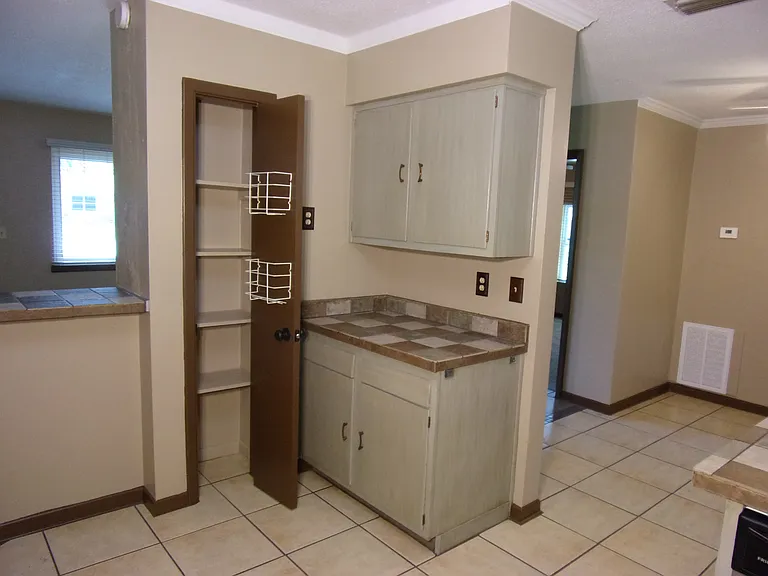 KITCHEN PANTRY AND PEEK AT DINING AREA