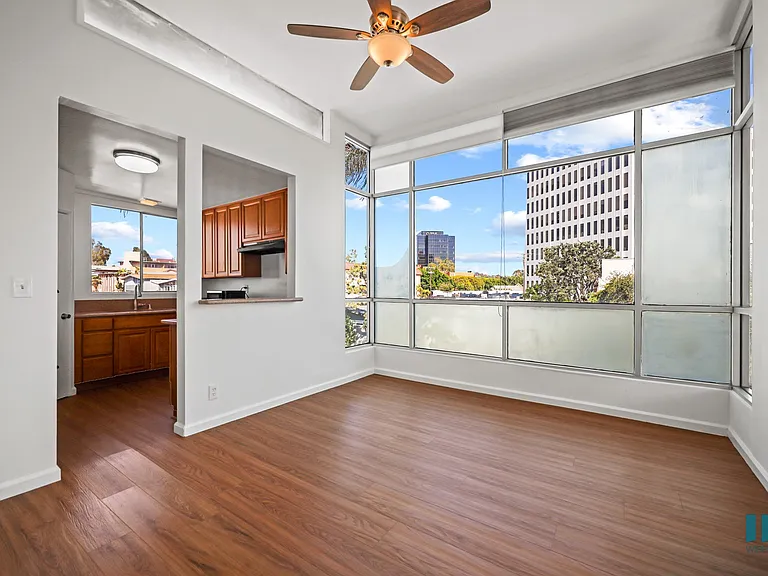 Kitchen and Dining Area with Large-Size Windows and Hardwood Flooring