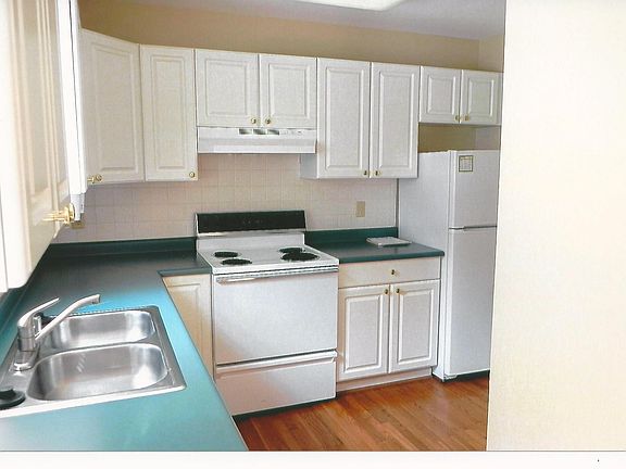 Kitchen has dishwasher, disposal, range, refrigerator, double sinks, and washer/dryer. Good amount of cabinets.