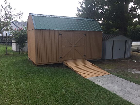 10x16 Shed with Power. 10x8 Metal Shed. Poly Chest on side of house for additional small storage.