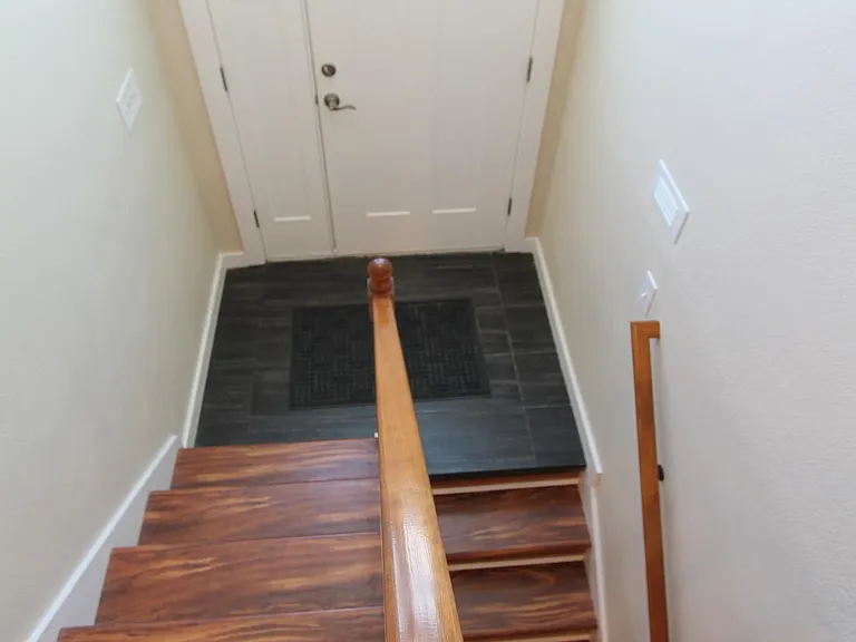 Staircase showing front door.
