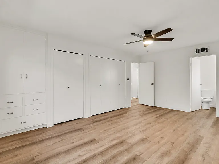 Primary bedroom with clothes and linen closet