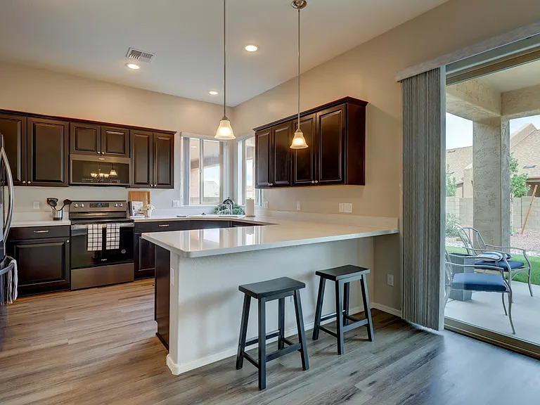 Kitchen with granite counter and bar seating.