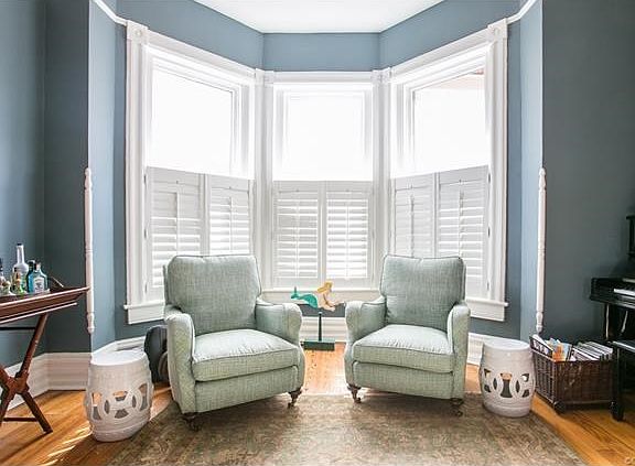 Large, bright parlor (living room) with 11 foot ceilings and hear pine floors!