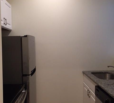 Kitchen with granite counter tops and porcelain tile back splash/SS appliances