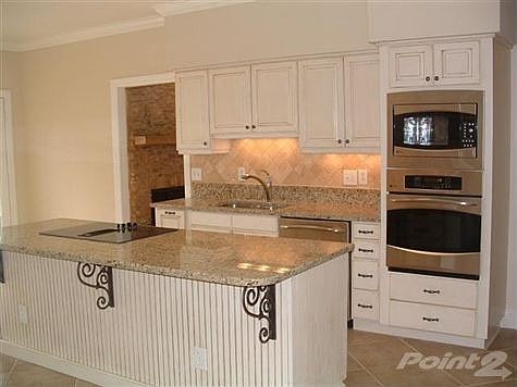 VIEW OF COMPLETELY UPDATED KITCHEN INCLUDING NEW GRANITE, TILE, STAINLESS GE PROFILE APPLIANCES.