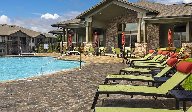 Sundeck and lounge chairs surrounding the pool