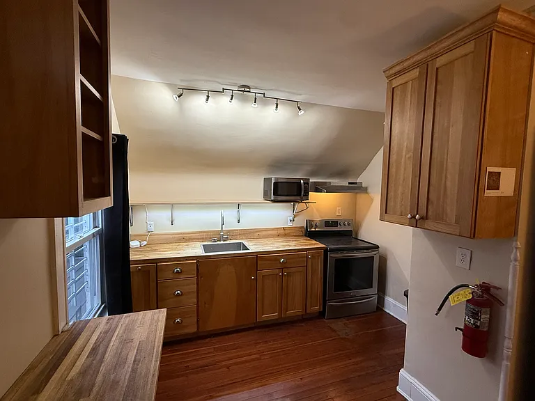 kitchen has oven, microwave, fridge, accent lights