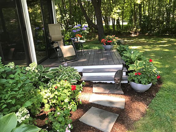 Peaceful backyard deck accessible from bedroom overlooks expansive lawn with old growth oaks and woodland meadow. Apartment inside is pet free.