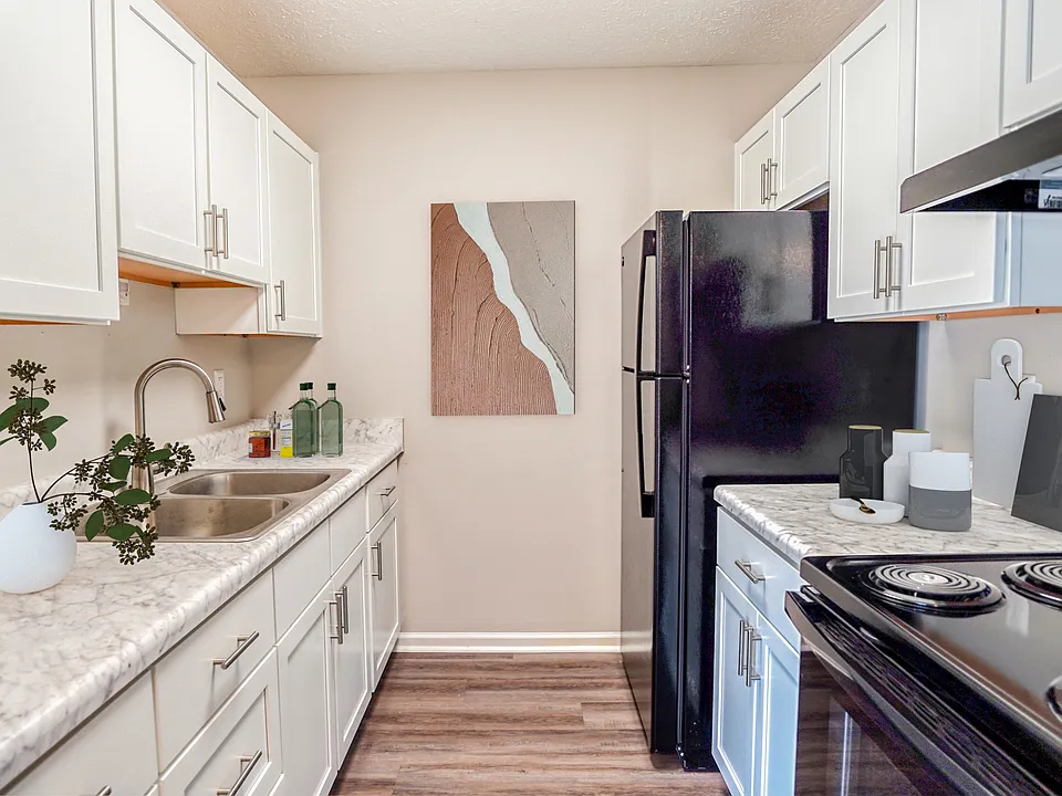 Step into the inviting kitchen of Green Valley, showcasing modern appliances and sleek cabinetry that elevate your cooking experience. Enjoy a blend of style and functionality. Explore your new home today!