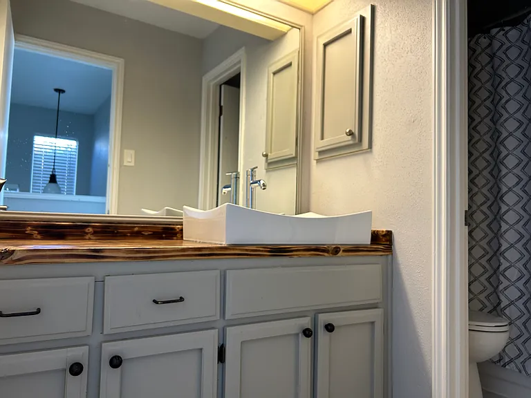 Vanity is in it's own space with the toilet and tub/combo behind a door if you desire a little privacy.