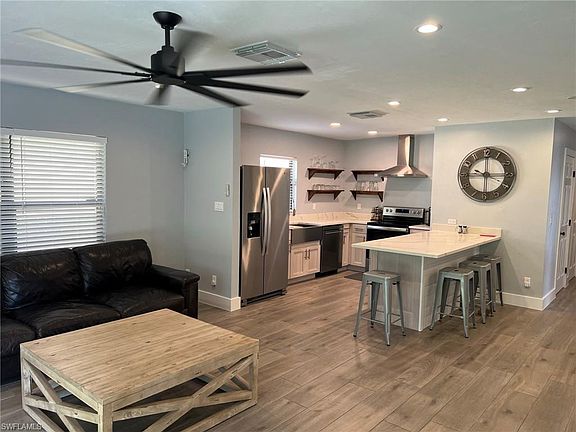 Kitchen features white quartz counter tops and stainless steel appliances