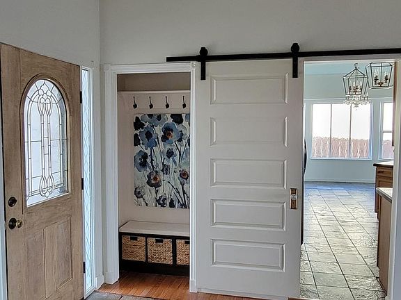 Front door, foyer, and coat/shoe closet.
