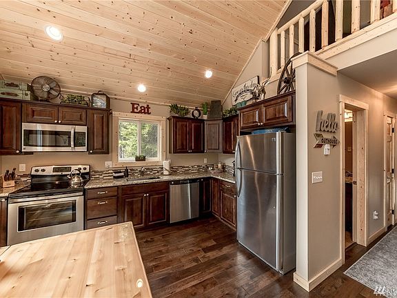 Fully appointed kitchen with stainless steel appliances and granite countertops. 