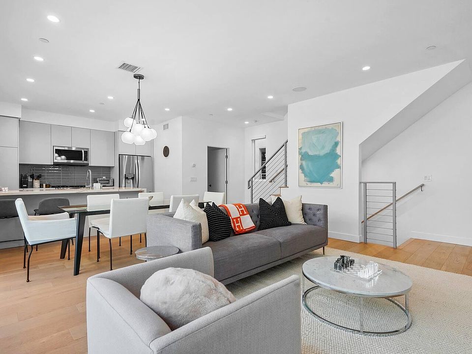 Relax and enjoy the seamless indoor-outdoor flow with the living room opening up to a balcony, offering a cozy seating area.