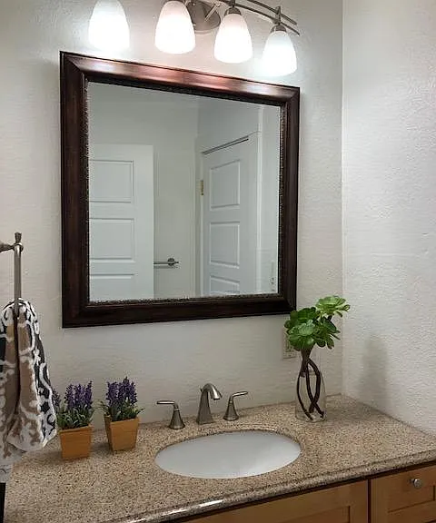 Large maple shaker wood vanity and granite counter top.