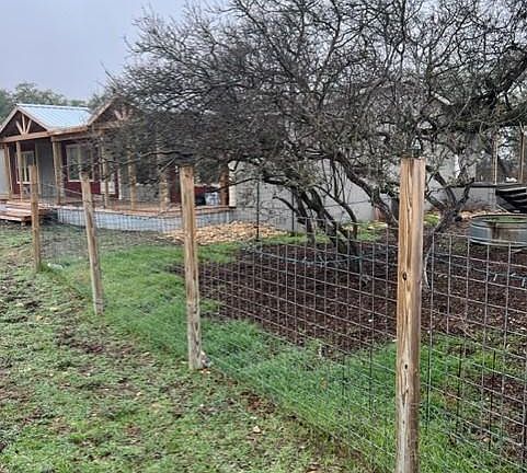 The yard is fenced with 4 x 4 welded wire fencing.