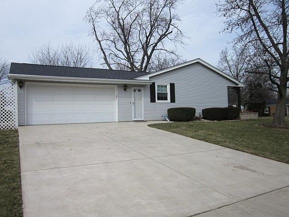 Over sized garage has a work bench and lots of storage room.