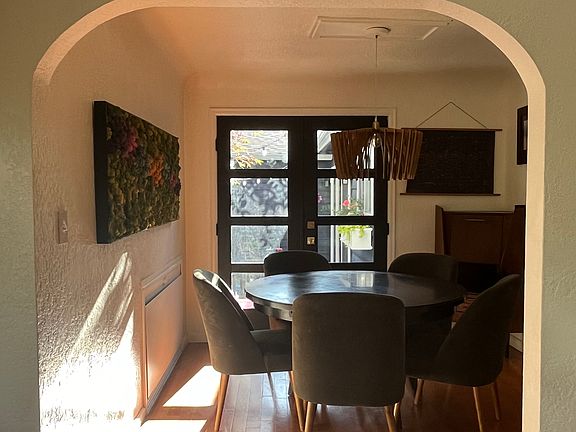 arched detailing into dining room, french doors lead out to patio