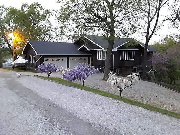 Wisteria trees line the driv